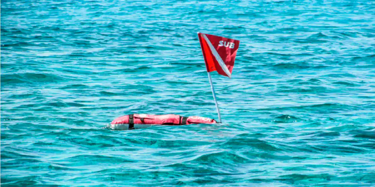 when you see a red flag with a white diagonal stripe (divers-down flag/device), you must